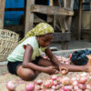 Ghanaian woman selling onions in the street.
