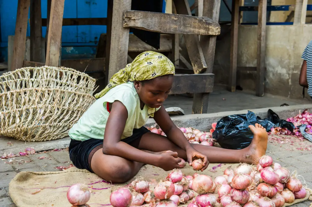 Ghanaian woman selling onions in the street.